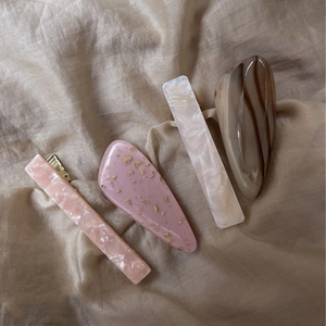 Detailed set of acetate hair clips featuring marble patterns and gold leaf flakes
