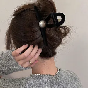Elegant black velvet hair claw clip with large silver pearl accent for women's hair styling