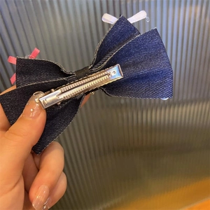 Blue denim bow hair clip with rhinestones and metal spring clip for elegant styling