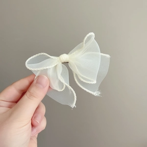 Elegant cream fairy-style layered organza bow hair clip with decorative woven edges