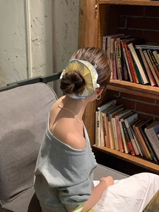 French style oversized yellow striped hair scrunchie shown on a high bun hairstyle