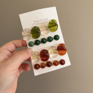 Close-up of vintage resin hair clip set with wavy patterns and beaded designs
