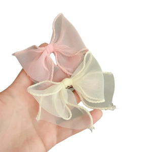 Fairy style mesh bow hair clips in pink and beige with wavy stitched edge detail