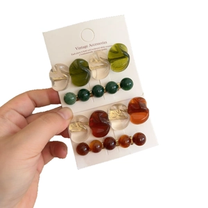 French retro style hair clips set with emerald resin beads and amber acrylic accents