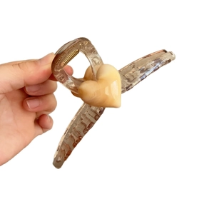 Brown translucent 13cm heart hair claw clip for thick hair shown in a side view