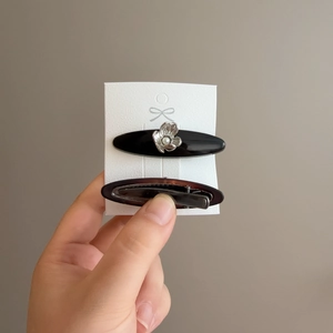 Set of two elegant geometric acetate hair clips with rhinestone heart and pearl accents