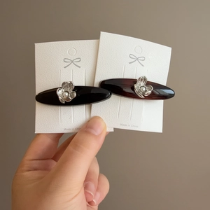 Elegant tortoiseshell and black heart acetate hair clips with pearl flower accents