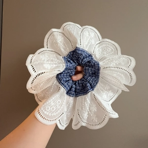 Sweet multi-layer blue gingham and white lace ruffled hair scrunchie held by hand