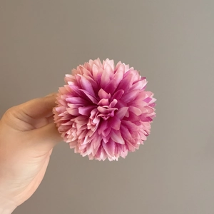 Macro detail of a layered pink-purple gradient petal hair clip with realistic fabric texture