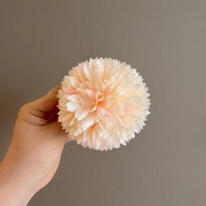 Detail shot of multi-layer pale pink floral hair clip with realistic fabric petals