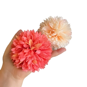 Handheld pair of layered petal hair clips in peach and beige dopamine color style