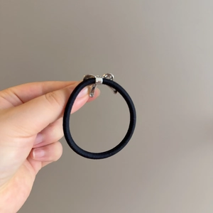 Minimalist elastic hair tie with a polished silver metallic bow knot accessory