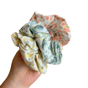 Three-piece set of floral print scrunchies in yellow, blue and pink dopamine colors