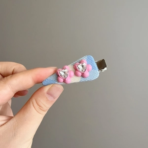 Sweet blue fabric hair clip with pink flowers and heart-shaped rhinestone details