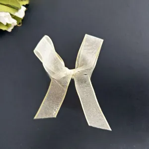 Detailed macro view of light gold chiffon ribbon bow clip with alloy non-slip teeth