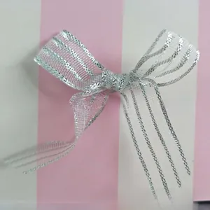 Macro detail of white mesh bow hair clip with silver glitter and non-slip alloy teeth