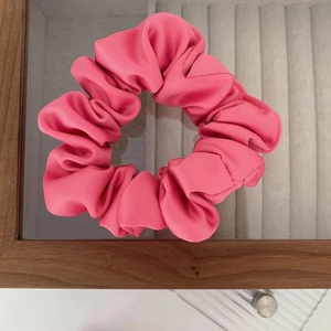 Vibrant rose pink satin scrunchie with voluminous pleated texture and silky shine