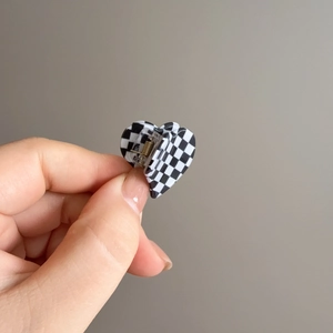 Checkerboard heart claw clip with black and white pattern and gold metal spring