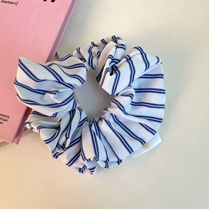 Minimalist blue striped scrunchie hair tie made of soft fabric for ponytail styling