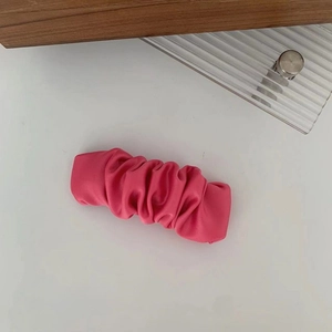 Pink ruched leather scrunchie hair clip with a stylish cloud pleated design on white board