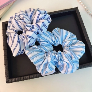 Minimalist blue striped scrunchie set with two elegant hair ties in a black tray