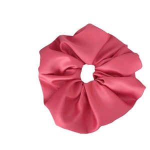 Rose pink oversized satin scrunchie with soft silk luster on a white background