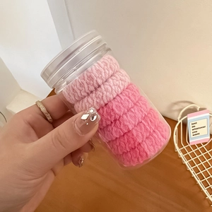 Pink high elasticity hair ties set with fine pleated texture in a clear storage jar