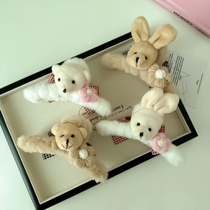 Détail de pinces à cheveux en peluche ours et lapin avec des nœuds à carreaux