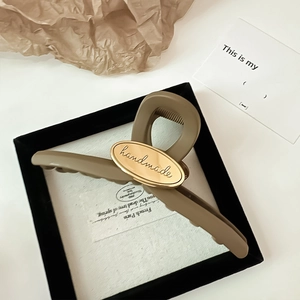 Large matte khaki shark hair claw clip with golden handmade oval plaque for women