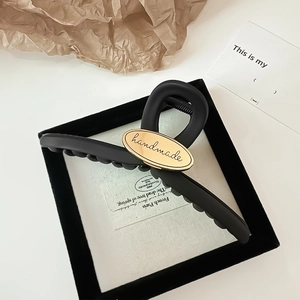 Elegant large matte black shark hair clip with oval gold handmade metal plate detail