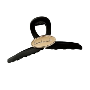 Matte black oval hair claw clip with golden handmade letter engraving for women