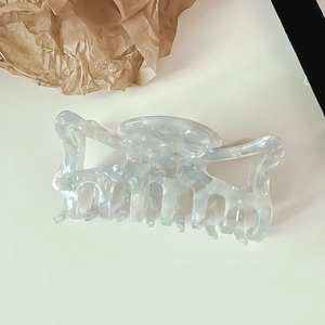 Detailed macro view of pearlescent marble texture on a large hair claw clip