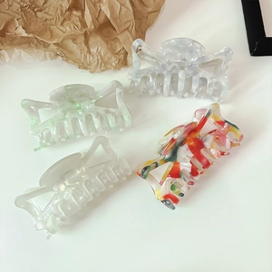 Set of four elegant acetate hollow bow hair claws in marble and pearl patterns