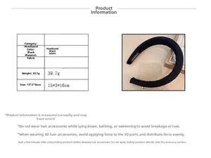Detailed view of the black fabric headband with interior handmade label and size specifications