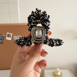 Elegant tweed hair claw clip with black and white fabric and large central rhinestone