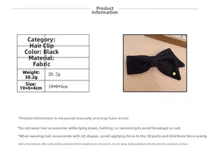 Detail view of black tweed bow hair clip with gold bead and 19x6x4cm size info