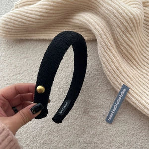 Elegant black tweed headband with gold buttons and an asymmetrical bow for a chic look