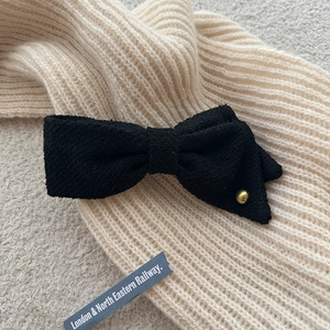 Elegant black tweed asymmetrical bow hair clip with gold bead and vintage texture