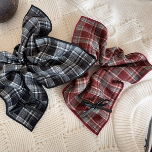 Vintage plaid bow scrunchies in black and red check patterns on a soft knit background