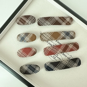Close-up of 8-piece vintage plaid fabric hair clips in oval and rectangular shapes