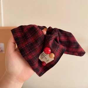 Classic red and black plaid fabric scrunchie with bead charms and minimalist woven label