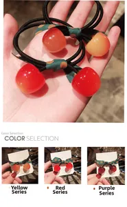 Detailed view of elastic cherry hair ties with colorful charms and polka dot bow accents