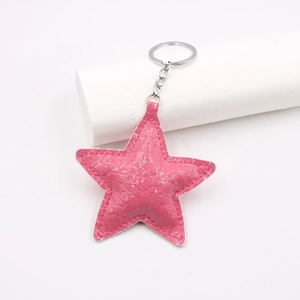 Sparkly pink star-shaped keychain with crocodile texture and silver metal chain