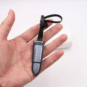 DIY 3D bullet-shaped leather bag charm with grey and black stitching and lanyard