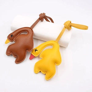 Detail of creative roasted duck leather bag charms with lychee texture and hand-stitched eyes