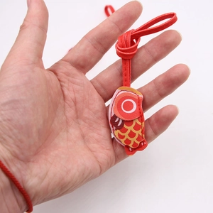 Red leather carp pendant charm with fine stitching for bags and keyrings held in hand