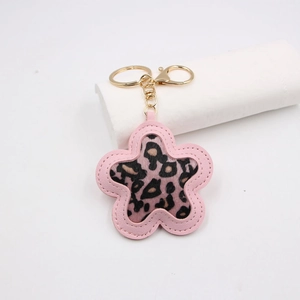 Pink leopard print flower keychain accessory with gold hardware and PU leather edge