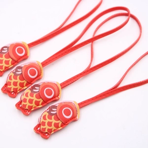 Detailed view of four red koi fish fabric pendants with yellow scales and red lanyards