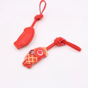Detail of red carp leather pendants showing fish scale pattern and red back
