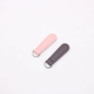 Detailed view of pink and brown pebble leather DIY zipper pulls with silver D-rings